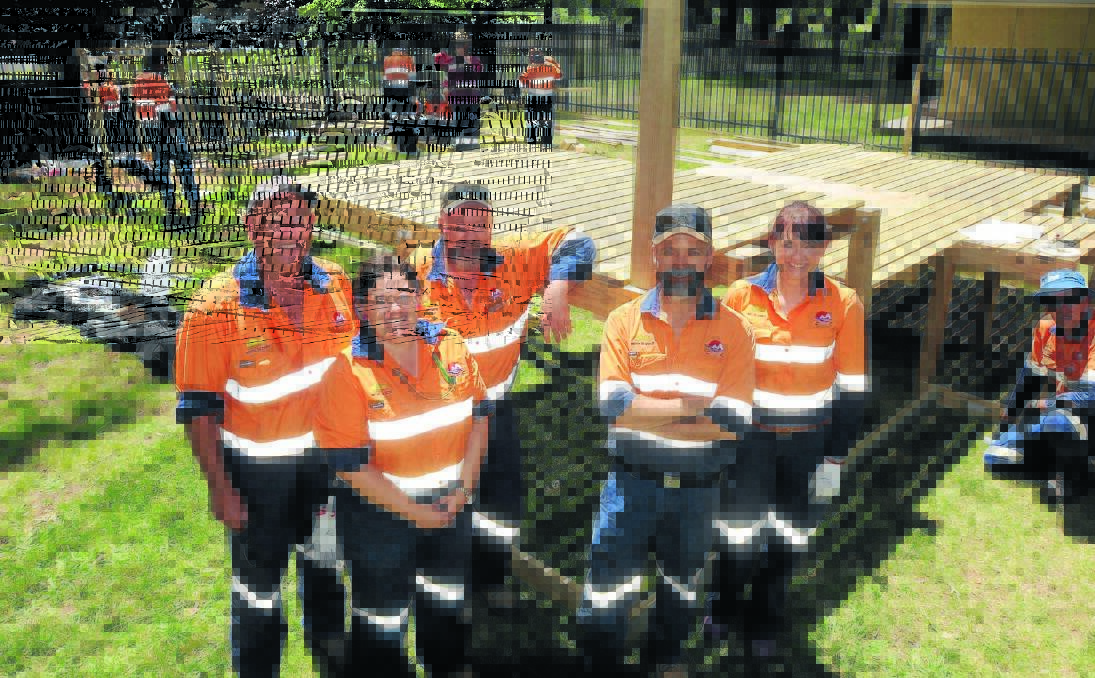 MINERS WITH A HEART OF GOLD: Northparkes Mines workers Wayne Medlyn, Michelle Row, Jim Davis, Peter Hannelly and Kellie Jones helped built a cubbyhouse at Ronald McDonald House yesterday.