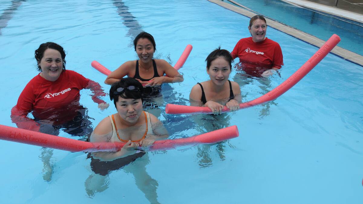 TAKING THE PLUNGE: Swimming instructor Claudette Andrie with students Angela Yang, Sun Bak, Viet Nguyen and fellow instructor Penny Goldhagen. Photo: STEVE GOSCH 0324sgpool2