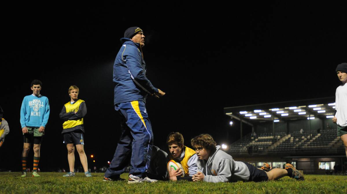 THIS IS HOW WE DO IT: The ARU's Garry Walsh runs Orange City's forwards through some drills on Tuesday night. Photo: STEVE GOSCH 0805sgrugby3