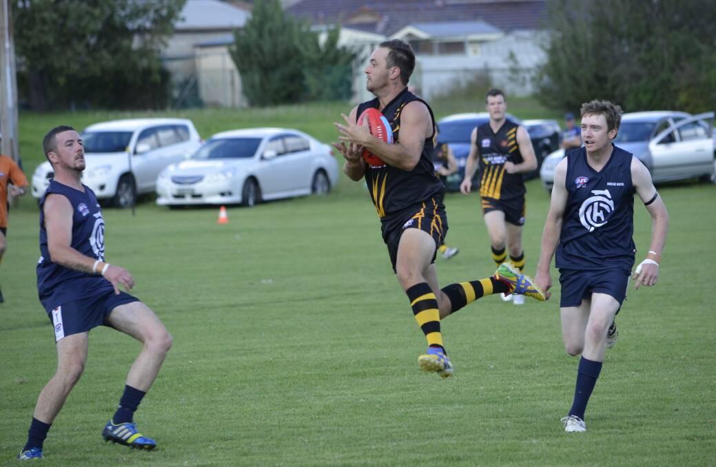 NEW RECRUIT: Paul Jenkins takes one on the chest on the way to kicking the first goal for the Orange Tigers in their Central West AFL win over Cowra on Saturday. 				  Photo: DAMIEN JOHNSON