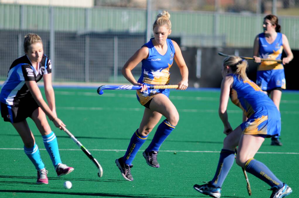 COMMENCE HOSTILITIES: Sam Hopwood (centre), moved from Ex-Services to Bathurst City this season, and takes on her former teammates today. Photo: STEVE GOSCH 0525sghock2