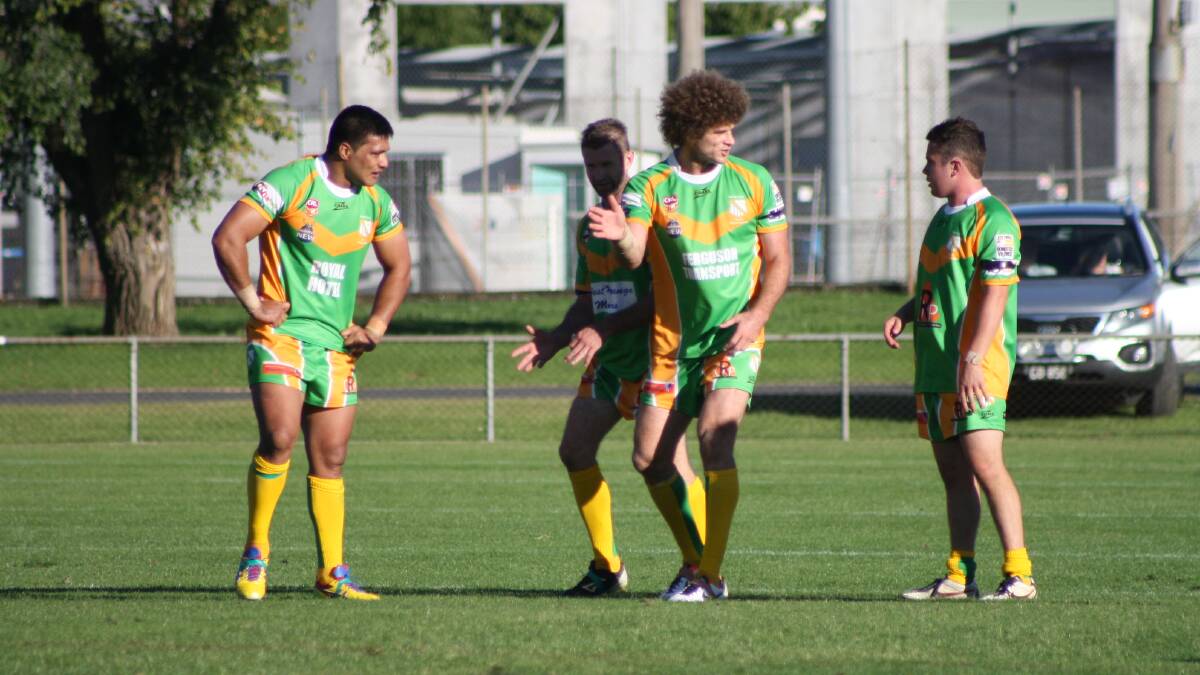 THE KING AND I: Matt King (second right) helps run Semisi Katoa (left), Warick Colley and Sam Hill through a few ideas during last Sunday's derby with Hawks. 
Photo: MICHELLE COOK 0406mcderby14