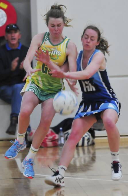 TOUGH BATTLE: CYMS Gladiators' Beth Curtin fights Kinross 1sts' Maddy Hawthorne for possession on Saturday. Photo: JUDE KEOGH 0614netball11