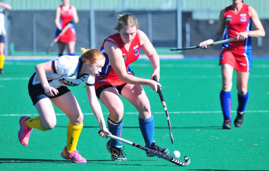 THE ONLY WAY IS UP: Kinross-CYMS youngster Annabelle Tierney tackles a Confederates opponent in last weekend's women's Premier League Hockey clash.
Photo: JUDE KEOGH 0809womhock11