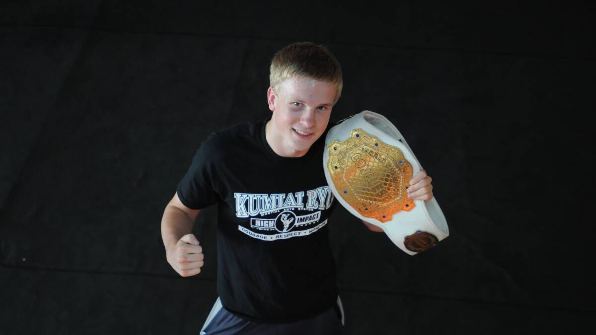 WORLD BEATER: Charlie Bubb holds the Super Middleweight MASA amateur world title belt he won on Saturday. Photo: STEVE GOSCH 1202sgbubb2
