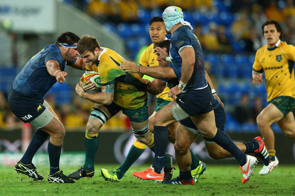 PUSHING AHEAD: Former Kinross Wolaroi student Ben McCalman buts through the Argentinian defence for the Wallabies in their Castrol EDGE Rugby Championship match last weekend. Photo: GETTY IMAGES
