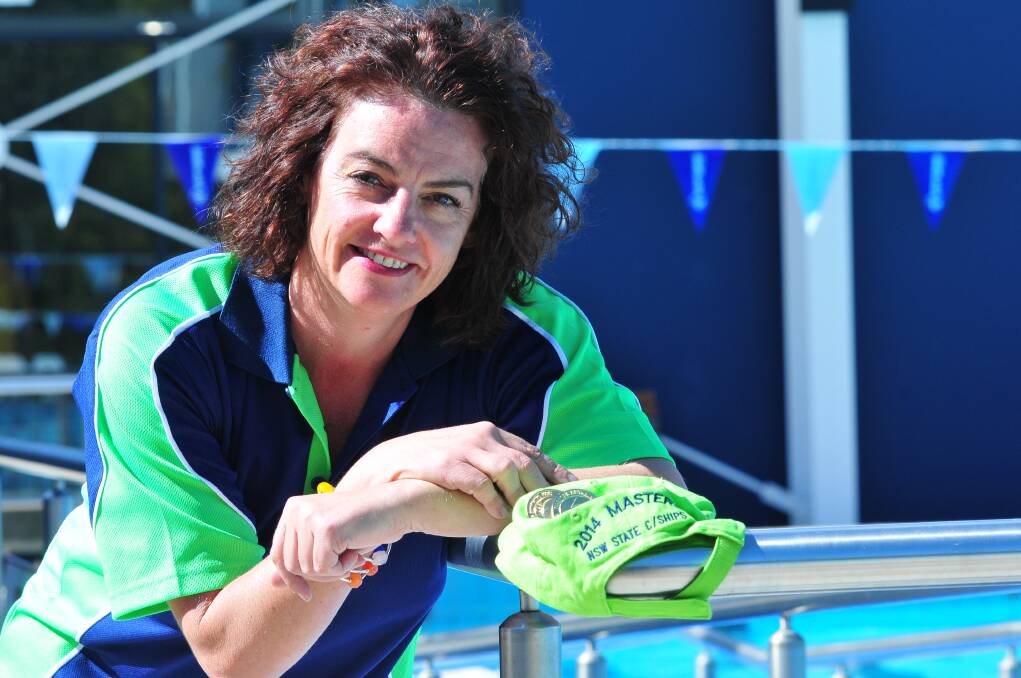 MIDAS TOUCH: Cathy Marshall showing off her two gold medals from the NSW Masters Long Course Championships. JETS teammate Zoe Dowsett also won five gold medals. Photo: JUDE KEOGH 0423swim3