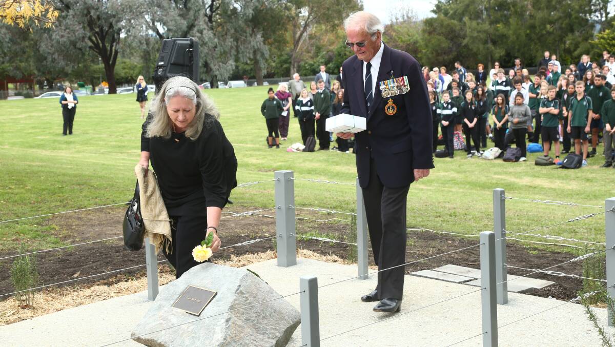 IN MEMORY: Kerry and Graeme Harris lay a tribute on the family's behalf Canoblas Rural Technology High Anzac ceremony. Photo: PHIL BLATCH 0423pbcanobolas