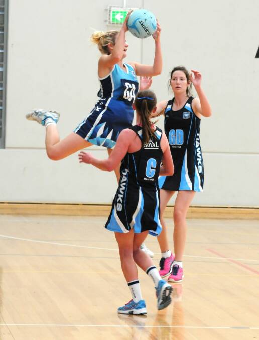 AIR TIME: KWS 1sts' Nikki Collins gets the jump on her Royal Hawks opponents on Sunday. Photo: STEVE GOSCH 0511sgnet3