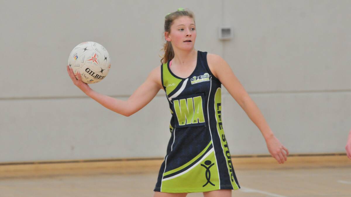 TITLE CONTENDERS: Brooke Burcher and her Life Studio teammates want to solidify their position in the top two. Photo: JUDE KEOGH 0725netball6