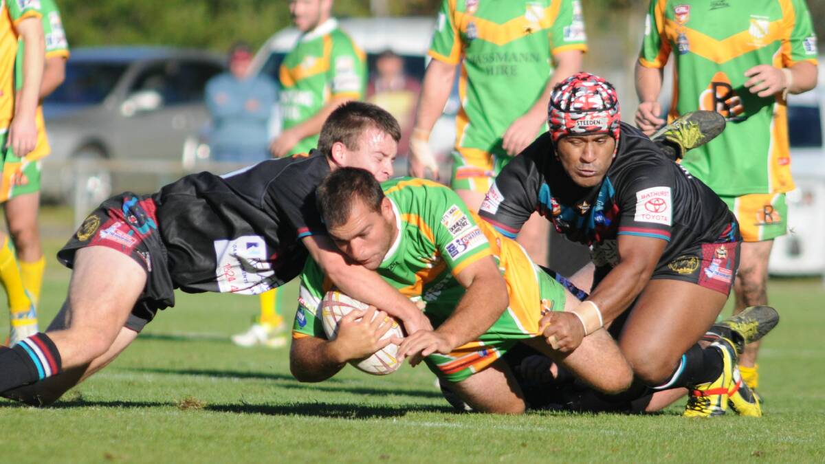 LOVING THE BUSH: Orange CYMS backrower Pat Galea is wrapped up by the Bathurst Panthers defence. Photo: STEVE GOSCH 0511sgleague2