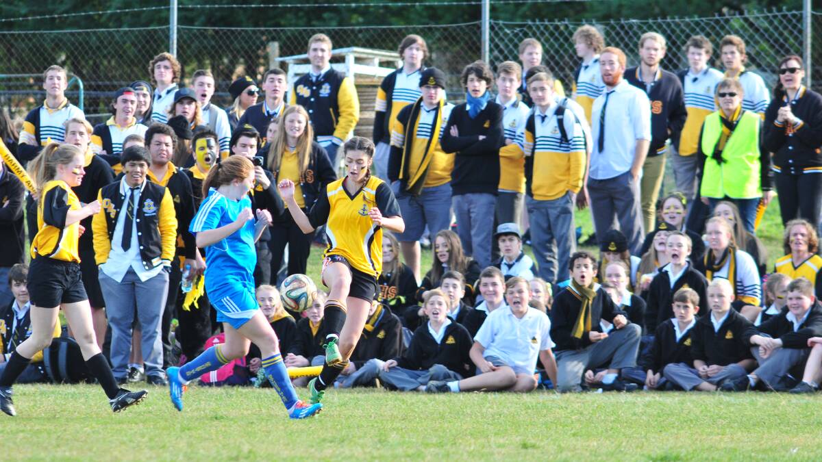 RIGHT BEHIND THEM: Orange High's Nikki Tamatea is given plenty of support from her schoolmates during the Astley Cup girls' football match last week against Bathurst High. Photo: JUDE KEOGH 0619astleysoccer3