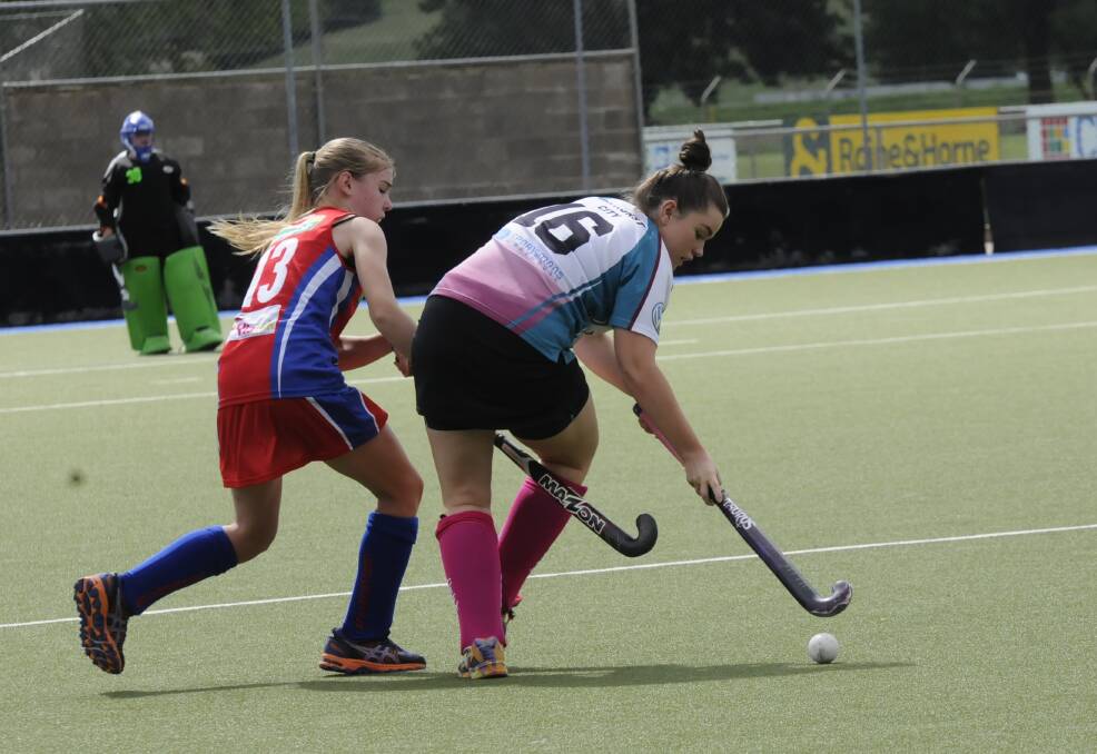 FIVE STRAIGHT: Bathurst City's Claire Sullivan keeps the ball away from Confederates' Grace Evans in Saturday's 6-1 win. Photo: PHILL MURRAY 040514pcity6