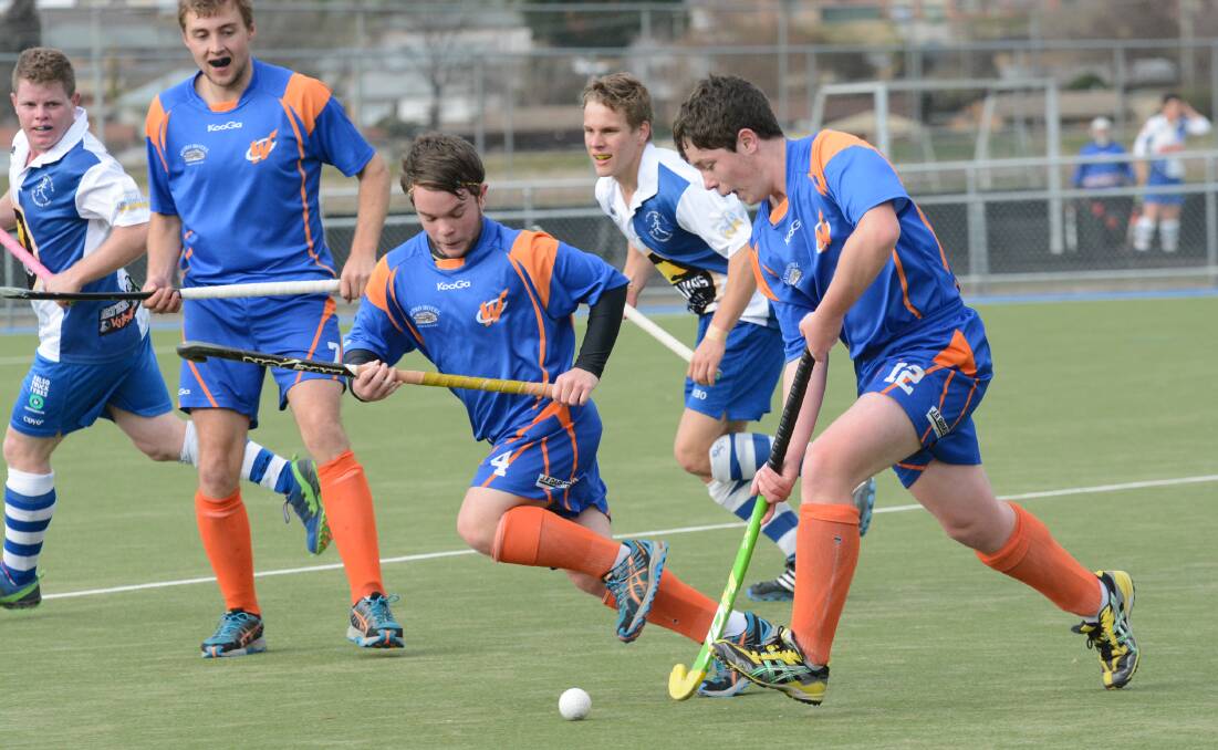TEAMING UP: Luke Skelton (centre) and Adam Skelton (right) attack the Bathurst St Pat's defence. Photo: PHILL MURRAY