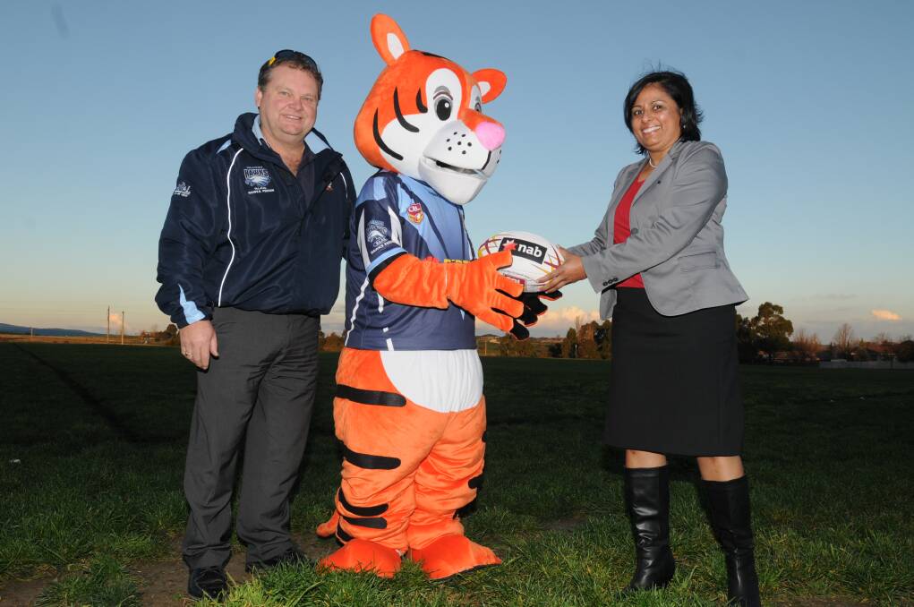 EYE OF THE TIGER: NAB Orange branch manager Sunila Kumar (right) presents Bloomfield Junior Rugby League Club mascot Tommy Tiger and treasurer Glen Robinson with a signed country ball.  Photo: STEVE GOSCH                                                         0605sgtiger