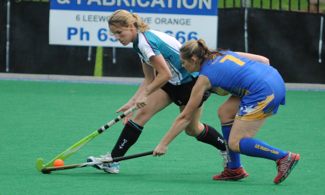 PRESSURE: Bathurst Citys' Casey Bayliss (left) is tested by Ex-Services’ Leanne Kennewell in their women's Premier League Hockey match in Orange. Photo: STEVE GOSCH 0329sghock5