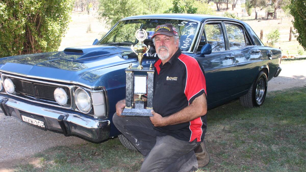 PASSIONATE: Greg Robbins, with his 1970 Ford XW Falcon and his 2013 NSW State Championship Series runner-up trophy, is urging people to get involved in drag racing in the region. Photo: MATT FINDLAY 0131mfdrag2