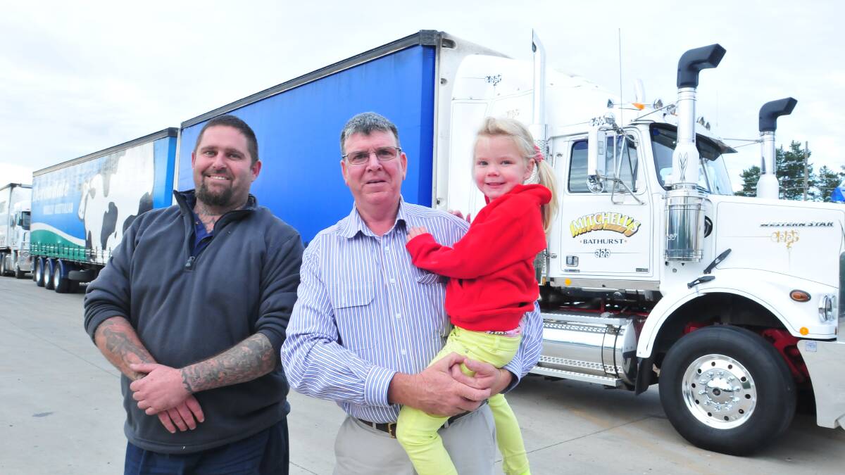WIN-WIN: Orange truck driver Wally Press (left) approached councillor Glenn Taylor (right, with daughter Annie Taylor) for truck stops on the Northern Distributor Road and says B-double routes in and out of Orange are next on the list. Photo LUKE SCHUYLER 0509lstruck1