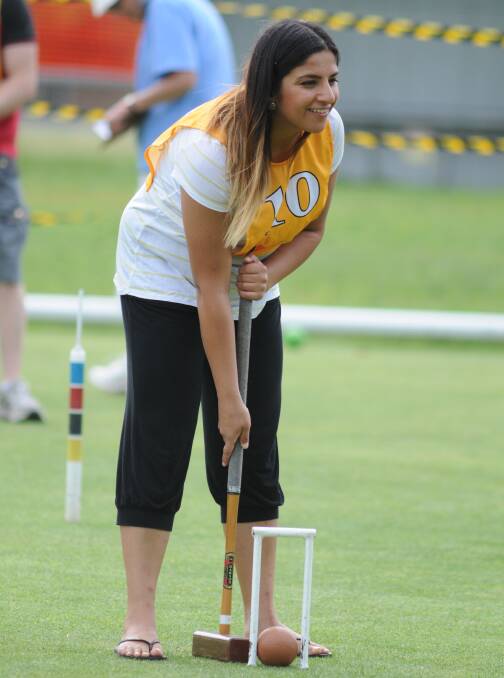 GREEN WITH ENVY: Amna Khan gets involved during the croquet games. Photo: STEVE GOSCH 1120sggames1
