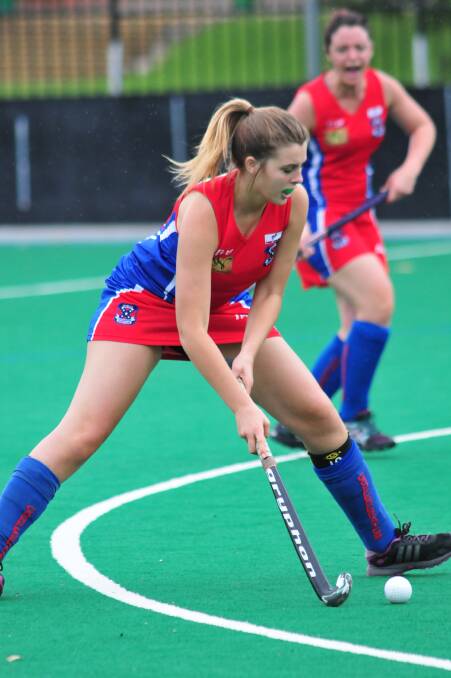 IMPROVING: Tayla Middleton and her ’Feds teammates are looking to score their first win of the season today. Photo: JUDE KEOGH 0315womhock1