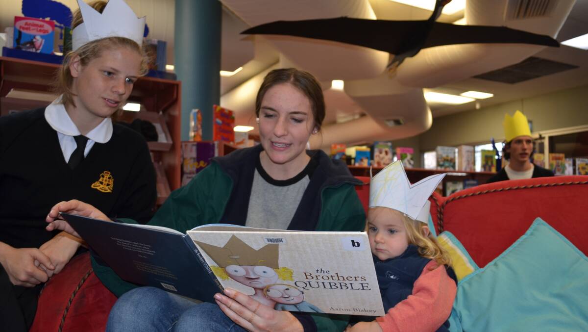 GETTING INTO READING EARLY: Orange High School drama student and play director Freya Hawke with actress Helena Griffith reading The Brother’s Quibble to Eleanor Crump and sharing the importance of reading. Photo: ASHLEA PRITCHARD 0527apstorytime1