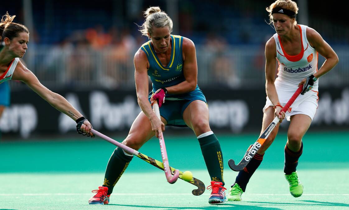 CLOSING IN: Orange's Eddie Bone (centre) fights for possession as the Netherlands' Lidewij Welten (left) and Carlien Dirkse Van Den Heuvel (right) surround her during the World League semi-final in Belgium. Photo: GETTY IMAGES