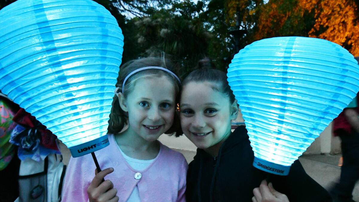 BLUE LIGHTS: Sarah King and Jasmine Hunt join in on the Light the Night fundraiser in Cook Park on Friday. Photo: JUDE KEOGH 1110jklight14