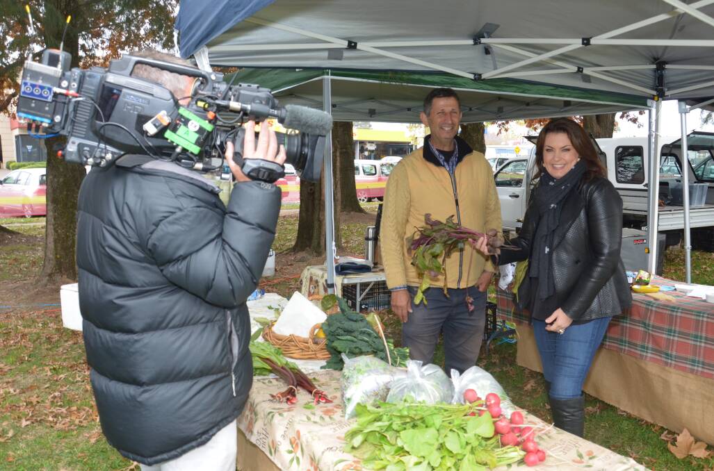 BEHIND THE SCENES: Spring Hill farmer Sam Samimi and Better Homes and Gardens presenter Karen Martini chat about produce. Photo: DECLAN RURENGA 0513drmartini1