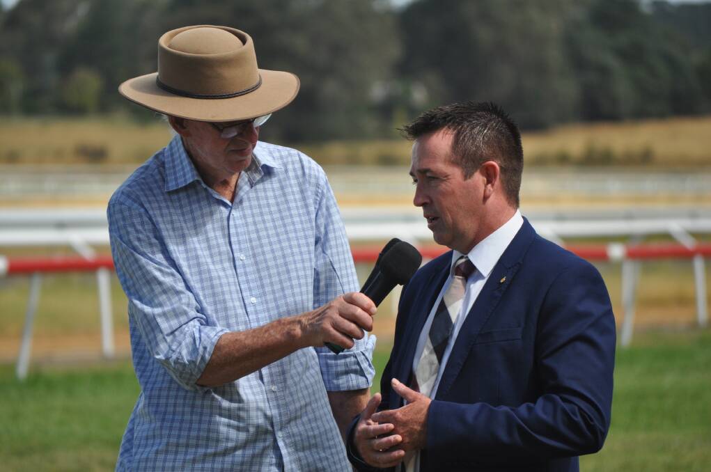ON TRACK ACTION: Terry Neil interviews NSW racing minister Paul Toole trackside at Towac Park during a break in the action on Sunday.