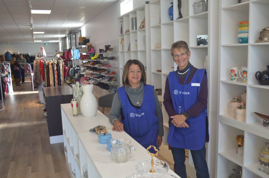 NO ORDINARY BOUTIQUE: Volunteers Michele Callaway and Jennifer Murphy in Vinnies new store on Peisley Street. Photo: DECLAN RURENGA 0529drvinnies1