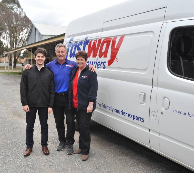 FAST MOVE: Fastway's Mike and Karen Andrew with driver Anthony Assante (left). Photo: JUDE KEOGH 0901jkfastway1