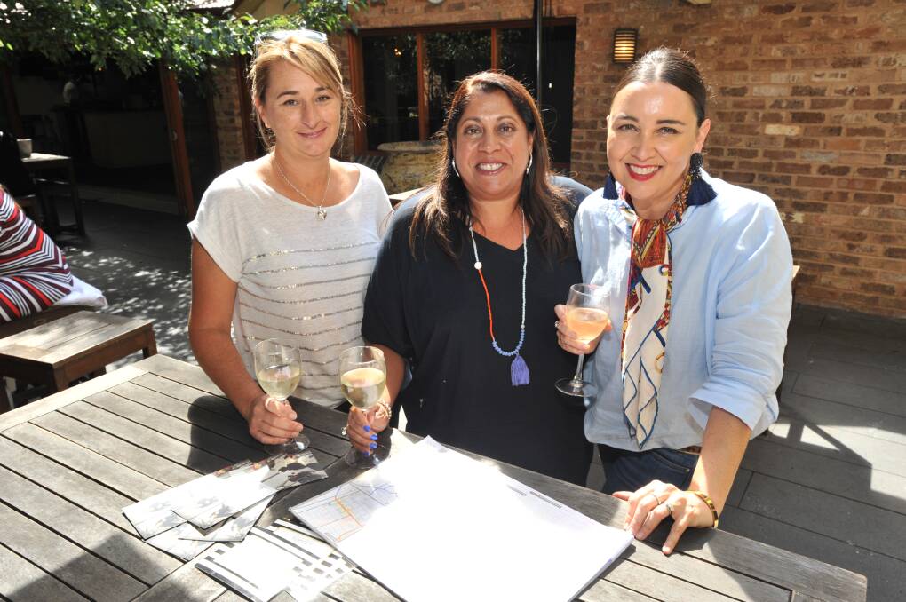 MAKING A LIST: Kylie Pryse Jones, Cheryl Leotta, Kellie Rigney consult a map ahead of a visit by parents from St Ignatius' College Riverview from Sydney. Photo: JUDE KEOGH 0324jkriver1