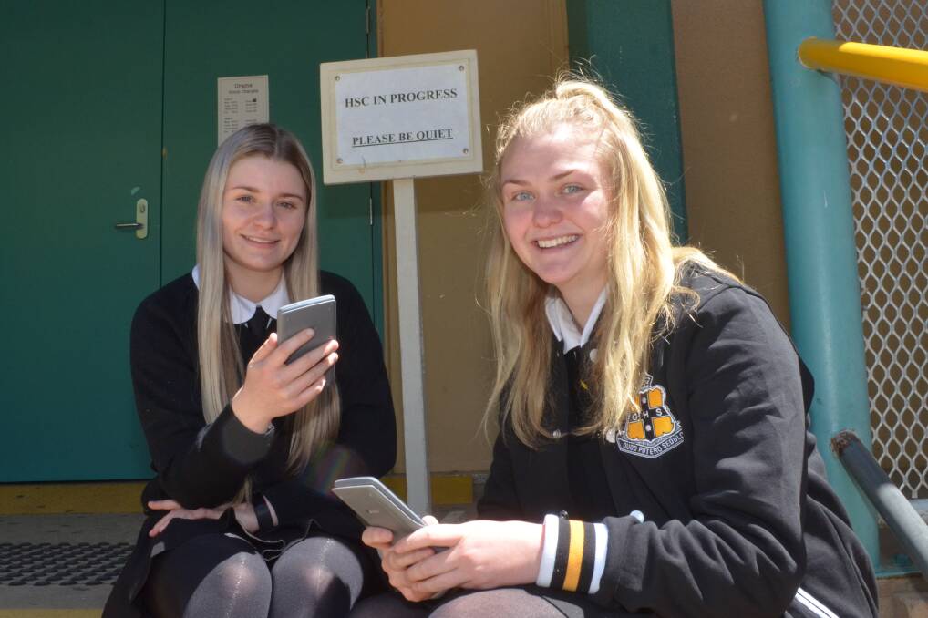 CHECKS OUT: Orange High School students Poppy and Rachael check an equation after their Senior Science HSC exam on Wednesday. Photo: DECLAN RURENGA 1018drhscsci