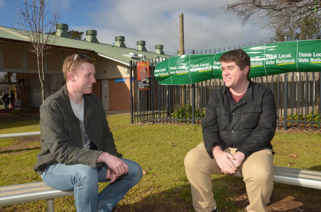 Orange's Thomas McCann and David Neill from Newcastle chat about the candidates and issues ahead of voting at Orange Public School. Photo: DECLAN RURENGA