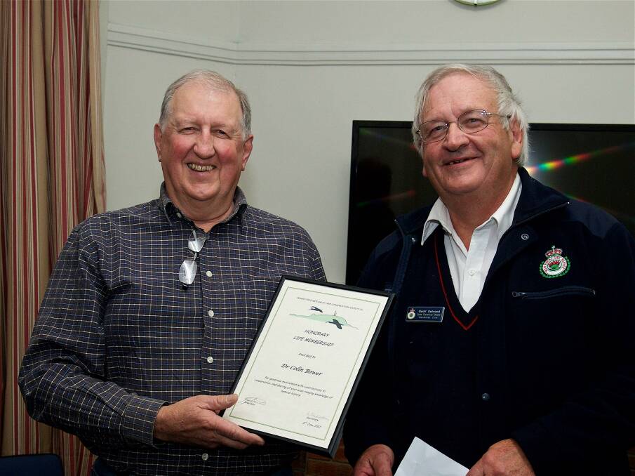 Col Bower receives life membership of the Orange Field Naturalist and Conservation Soceity from president Geoff Selwood. Photo: HELMUT BERNDT