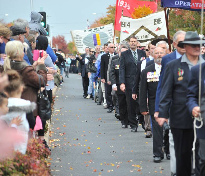 LEST WE FORGET: Veterans march towards the Cenotaph at Robertson Park on Tuesday. Photo: JUDE KEOGH 0425jkanzac14