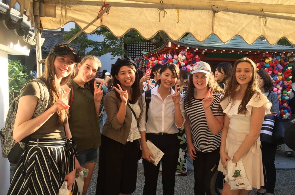INTER-CONTINENTAL: Orange students Kate Elliott, Georgia Beattie, Millie Balcomb and Charlotte Balcomb catch up with some locals in Japan. Photo: CONTRIBUTED