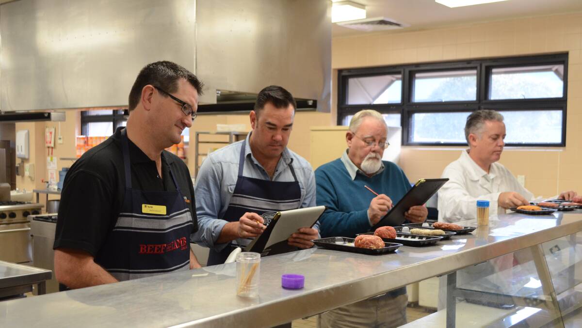 MEAT N' GREET: Judges Martin Bennett, Dennis Tuck and John Finlayson critique the burgers in the uncooked stage of judging with help from Australian Meat Industry Council Officer Craig Wright. PHOTO: Jake Humphreys