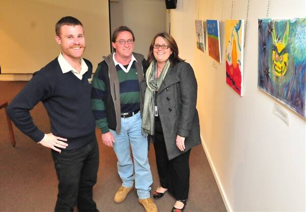 BOOSTING AWARENESS: Bruce Cherry from Hepatitis NSW with Brett Wilson and Roisyn Dyer at the Hep C and Me art show at the Orange Regional Gallery. Photo: JUDE KEOGH 0728art3