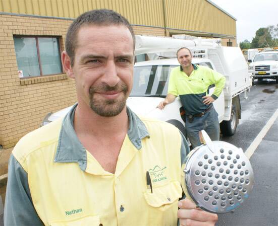HEAD ON: Orange City Council technical services staff Nathan Dean and Graeme Bright will hit the streets over the next three months installing free water-efficient showerheads.