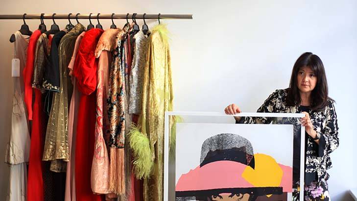 Everything must go … Lisa Ho with some of the garments she is selling at auction, as well as a print by Andy Warhol.