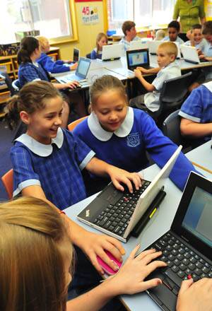 TECH SAVVY: Bletchington Public School year 5 students Caity Furlonger and Shayleigh Wilkins search the world wide web on their new laptops.