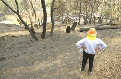 GONE: Orange and District Pistol Club president Roger Bond surveying the fire damage on the club grounds yesterday