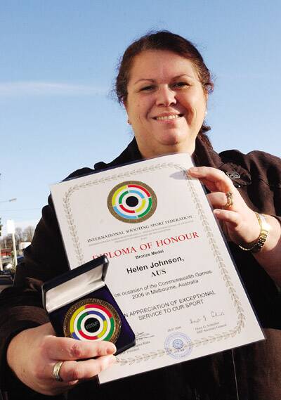 Helen Johnson shows off her International Sports Shooting Federation Diploma of Honour bronze medal received for service at the 2006 Melbourne Commonwealth Games.