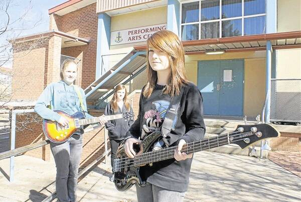WE WILL ROCK YOU: Members of the all-girl year 10 Orange High School rock band Rachael Bastiaansen on guitar, vocalist Bec Craig and Amanda Maguire on bass. Photo: MARK LOGAN 0605mlrockband1