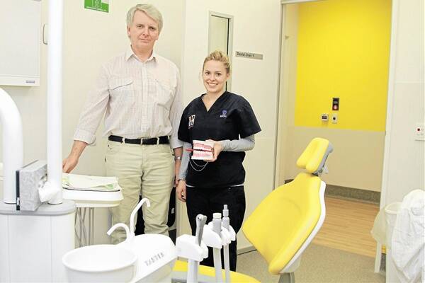 SERVICE FOR A SMILE: Dr Tom Hasson with oral health therapist Caroline Ridley in the dental unit at Orange hospital which has handled 10,000 appointments since it opened. Photo: JEFF DEATH                                                   0716jddental