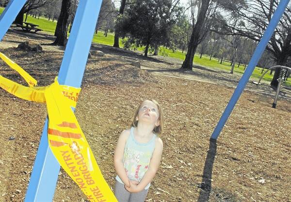 NO FUN: Haylee Govier will have to find something else to play on thanks to vandalism in Elephant Park. Photo: STEVE GOSCH   0918sgswing