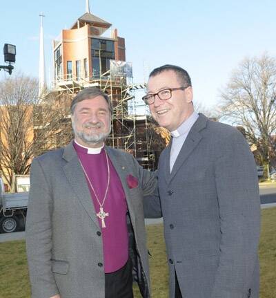 BELL RINGER: Anglican Bishop Richard Hurford and Fr Michael McKenna outside All Saints Cathedral.