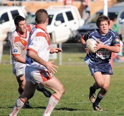 ON THE CHARGE: Orange Hawks’ Mitch Hurford tries to scoot around the Mudgee defence yesterday.