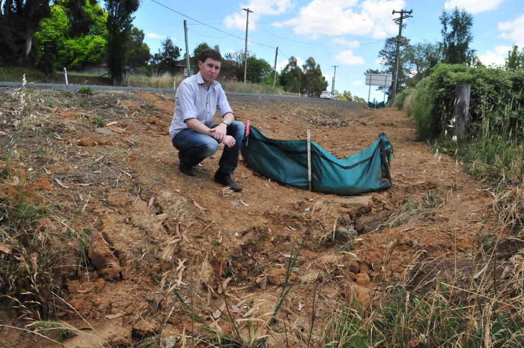 WATER WORLD: Brent Riach fears his Molong Road property will be inundated with more water and silt when Orange Anglican Grammar demolishes a home opposite his property to make way for a new sports oval. 	                                     Photo: JUDE KEOGH	